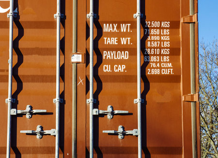 Detail of a brown steel container transporting goods on a heavy truck on Geran road