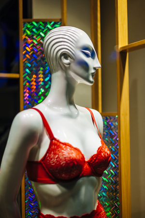 Elegant red bra on woman mannequin silhouette in showcase show windowの写真素材