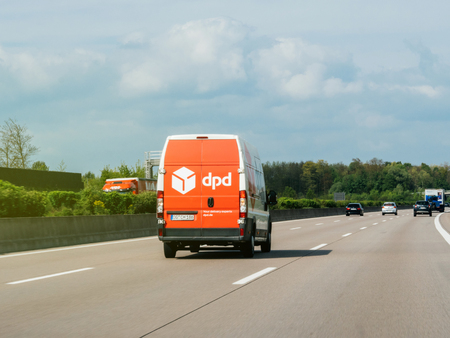 GERMANY - APR 13, 2017: White parcel DPD parcel delivery van in driving fast on German Highway Autobahn. DPD or Dynamic Parcel Distribution is an international parcel delivery company owned by GeoPost.のeditorial素材