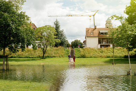 KEHL, GERMANY - JUN 18, 2016: Couple looking at flooded Rhine river at the border with France. In june large bodies of water has caused inundation of adjacent areas near the river.のeditorial素材