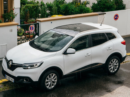 STRASBOURG, FRANCE - MAY 30, 2016: Rain drops over aerial view of a white Renault Kadjar SUV car...