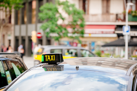 Taxi signage on the roof a classic taxi service car in Barcelona, Spainの写真素材
