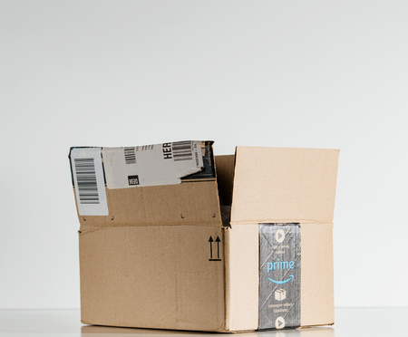 PARIS, FRANCE - JUL 30, 2017: Open Amazon Prime logotype printed on cardboard box side. Amazon is an American electronic e-commerce company distribution worlwide e-commerce goodsのeditorial素材