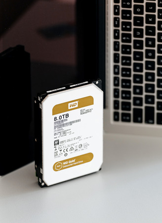 PARIS, FRANCE - JUL 28, 2017: Powerful Western Digital Hard data center hard drive wd gold series disk drive with 8 Terabytes capacity against laptopc computer background. Western Digital is the biggest storage data manufacture worldwideのeditorial素材