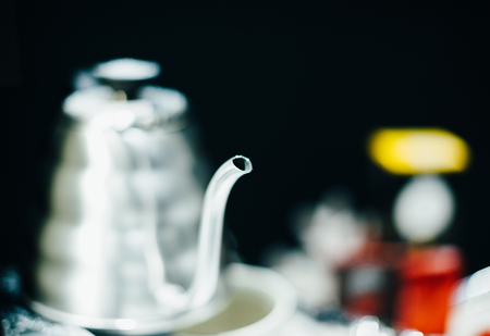 Kettle detail with beautiful focus on the nose - luxury kettle for herbal tea infusion in modern style made from steelの写真素材