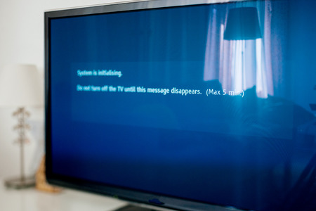 Living room with Modern TV and message - Do not turn the TV during update の写真素材