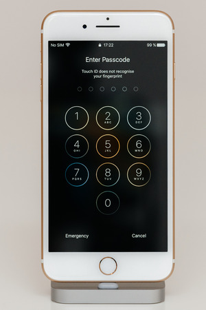 PARIS, FRANCE - SEP 26, 2016: New Apple iPhone 7 Plus in docking station after unboxing and testing by installing and running the app application software enter passcode scurity numberのeditorial素材