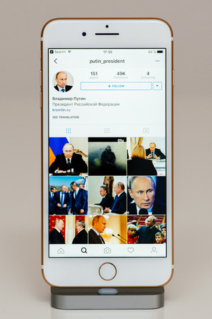 PARIS, FRANCE - SEP 26, 2016: New Apple iPhone 7 Plus in docking station after unboxing and testing by installing and running the app application software Vladimir Putin Instagram Accountのeditorial素材