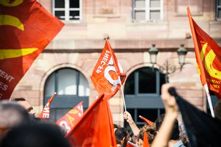 STRASBOURG, FRANCE - SEPT 12, 2017: Young communist movement flags at political march during a French Nationwide day of protest against the labor reform proposed by Emmanuel Macron Governmentのeditorial素材