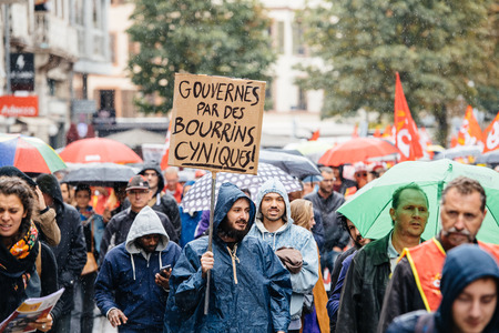 STRASBOURG, FRANCE - SEPT 12, 2017: Gouverne par des bourrins cyniques translated as governed by cynical bushes at male protest placard at anti-macron protest in Franceのeditorial素材
