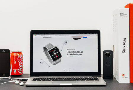 PARIS, FRANCE - SEP 3, 2017: Minimalist creative room table with Safari Browser on MacPook Pro laptop at Apple Computers website with latest Apple Watch Series 3 with streaming music itunesのeditorial素材