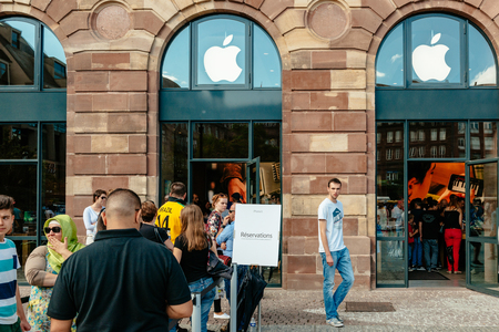 STRASBOURG, FRANCE - SEP 20, 2014: Customers waiting in line to pick-up their new reserved iPhone 7 from the Apple Store computer store selling iPad, Apple Watch and iMac MacBook pro computersのeditorial素材