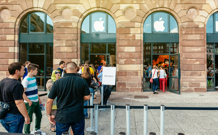 STRASBOURG, FRANCE - SEP 20, 2014: Customers waiting in line to pick-up their new reserved iPhone 7 from the Apple Store computer store selling iPad, Apple Watch and iMac MacBook pro computersのeditorial素材