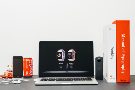 PARIS, FRANCE - SEP 13, 2017: Minimalist creative room  Safari Browser open on MacBook Pro laptop showcasing Apple Keynote website - Apple COO Jeff Williams presenting the Apple Watch 3 pricesのeditorial素材