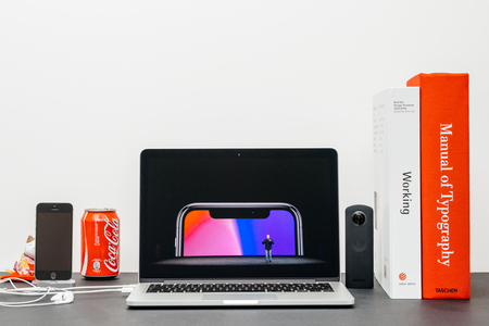 PARIS, FRANCE - SEP 13, 2017: Minimalist creative room and Safari Browser on MacBook Pro laptop showcasing Apple Keynote website with Phil Schiller Apple marketing chief  presenting the new iPhone X 10のeditorial素材