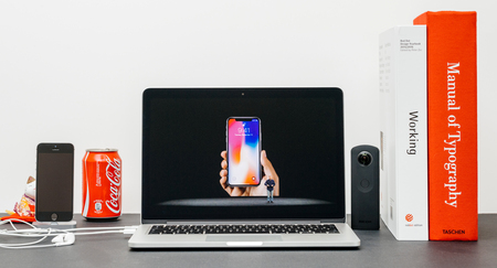 PARIS, FRANCE - SEP 13, 2017: Minimalist creative room and Safari Browser on MacBook Pro laptop showcasing Apple Keynote website with Phil Schiller Apple marketing chief  presenting the new iPhone X 10 locking methodのeditorial素材