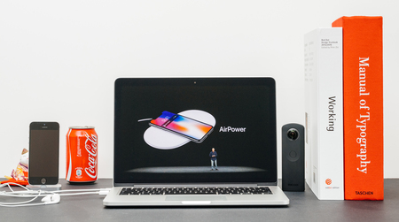 PARIS, FRANCE - SEP 13, 2017: Minimalist creative room and Safari Browser on MacBook Pro laptop showcasing Apple Keynote website with  presenting the new iPhone X 10 Air Power AirPower wireless chargerのeditorial素材