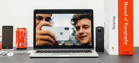 PARIS, FRANCE - SEP 13, 2017: Minimalist creative room and Safari Browser on MacBook Pro laptop showcasing Apple Keynote website resenting the new iPhone X 10 camera  photo rear view cameraのeditorial素材