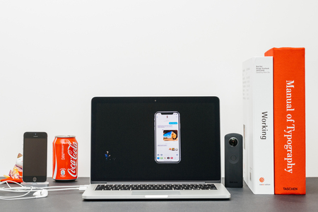 PARIS, FRANCE - SEP 13, 2017: Minimalist creative room and Safari Browser on MacBook Pro laptop showcasing Apple Keynote website with  presenting the new iPhone X 10 emoji with Tim Cookのeditorial素材