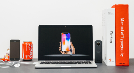 PARIS, FRANCE - SEP 13, 2017: Minimalist creative room and Safari Browser on MacBook Pro laptop showcasing Apple Keynote website with Phil Schiller Apple marketing chief  presenting the new iPhone X 10 locking methodのeditorial素材