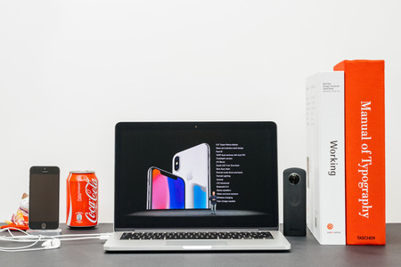 PARIS, FRANCE - SEP 13, 2017: Minimalist creative room and Safari Browser on MacBook Pro laptop showcasing Apple Keynote website with Phil Schiller   presenting the new iPhone X 10 specs for the phoneのeditorial素材