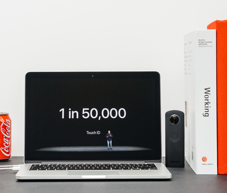 PARIS, FRANCE - SEP 13, 2017: Minimalist creative room and Safari Browser on MacBook Pro laptop showcasing Apple Keynote website with Phil Schiller presenting the new iPhone X 10 touch id errorのeditorial素材