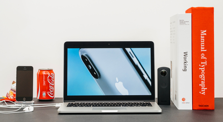 PARIS, FRANCE - SEP 13, 2017: Minimalist creative room and Safari Browser on MacBook Pro laptop showcasing Apple Keynote website presenting the new iPhone X 10 rear view photo cameraのeditorial素材
