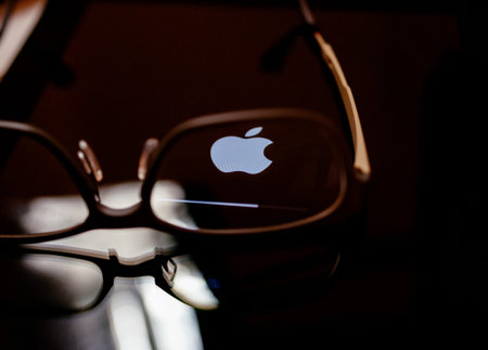 PARIS, FRANCE - SEP 12, 2014: Apple Computers logotype on the retina screen display of the latest iPad tablet displaying progress update loading bar through eye wear glassesのeditorial素材