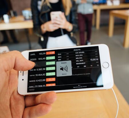 PARIS, FRANCE - SEP 22, 2017: New iPhone 8 and iPhone 8 Plus, as well the updated Apple Watch, Apple TV goes on sale today in Apple Store with customer POV at Altaba stock index at stocks appのeditorial素材