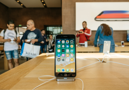 PARIS, FRANCE - SEP 22, 2017: New iPhone 8 and iPhone 8 Plus in Apple Store with home screen desktop apps and customers in the backgroundのeditorial素材