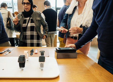 PARIS, FRANCE - SEP 22, 2017: New iPhone 8 and iPhone 8 Plus, as well the updated Apple Watch, Apple TV goes on sale today in Apple Store with Apple Genius selling Apple Watch iwatch to customerのeditorial素材