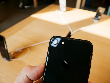 PARIS, FRANCE - SEP 22, 2017: New iPhone 8 and iPhone 8 Plus, as well the updated Apple Watch, Apple TV goes on sale today in Apple Store with customer looking at the iPhone camera 8 versionのeditorial素材