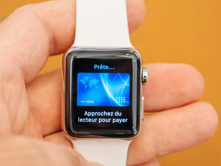 PARIS, FRANCE - SEP 22, 2017: New Apple Watch Series 3 goes on sale in Apple Store with man holding...