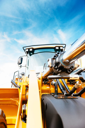 Front view of powerful excavator with beautiful blue sky in the background