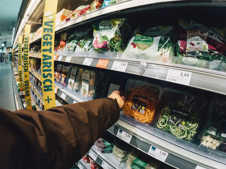 FRANKFURT, GERMANY - MAY 3, 2017: Male customer point of view buying vegan and vegetarian food in German supermarket Edeka - choosing the fresh carrots and salads for a healthy lifeのeditorial素材