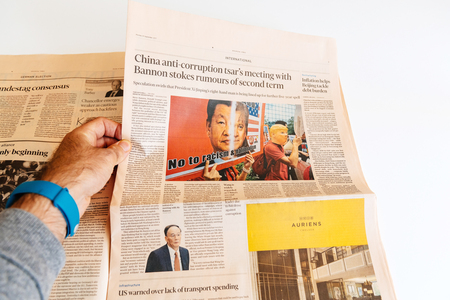 PARIS, FRANCE - SEP 25, 2017: Man reading international newspaper Financial Times about China anti-corruption tsarのeditorial素材