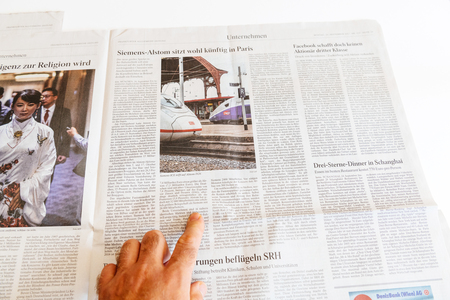 PARIS, FRANCE - SEP 25, 2017: Man reading German newspaper about Siemens and Alstom possible mergerのeditorial素材