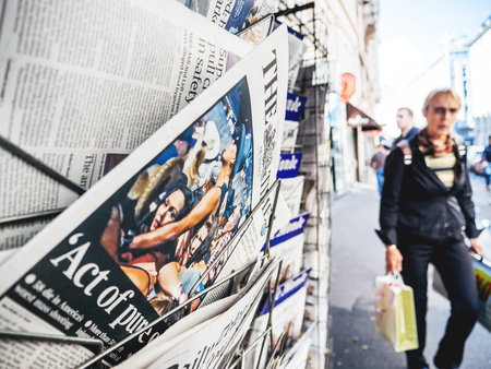 PARIS, FRANCE - OCT 3, 2017: Pedestrians near the Times newspaper with socking title and photo at press kiosk about the 2017 Las Vegas Strip shooting in United States with about 60 fatalities and 527 injuriesのeditorial素材