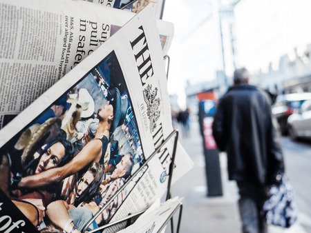 PARIS, FRANCE - OCT 3, 2017: Pedestrians near the Times newspaper with socking title and photo at press kiosk about the 2017 Las Vegas Strip shooting in United States with about 60 fatalities and 527 injuriesのeditorial素材
