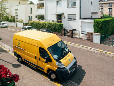 PARIS, FRANCE - JUN 23, 2017: La Poste yellow delivery van for the delivery on time package parcel - aerial viewのeditorial素材