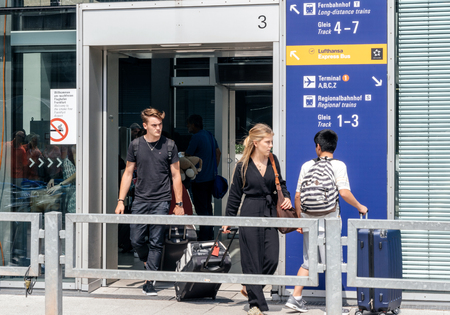 FRANKFURT, GERMANY - AUG 1, 2017: Young female and male passengers arriving with luggage at Frankfurt airport from Frankfurt airport long-distance train stationのeditorial素材