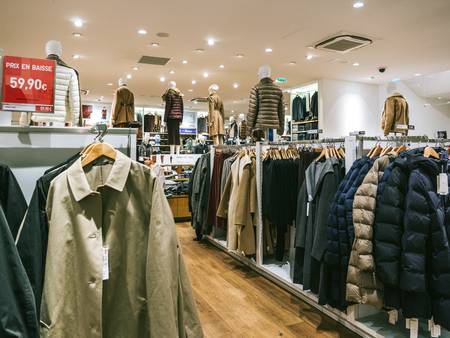 Fashionable warm female outerwear, down coats on display in empty shopのeditorial素材