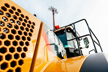 PARIS, FRANCE - SEP , 2014: View of a powerful yellow cat tractor parked on a construction site -...