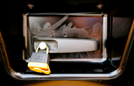 PARIS, FRANCE - SEP 5, 2014: CAT logotype on the security lock of a modern excavator tractor industrial machineのeditorial素材