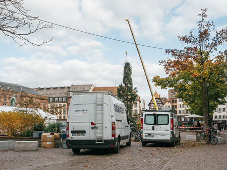 STRASBOURG, FRANCE - OCT 30, 2017: SWhite vans in Strasbourg Christmas Tree Install in central Place Kleber Square by gigantic crane for the upcoming winter holidaysのeditorial素材