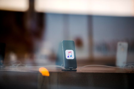 STRASBOURG, FRANCE - NOV 3, 2017: Latest Apple iPhone X goes on sale in Apple Store worldwide - demonstration animation of the phone charging in docking stationのeditorial素材