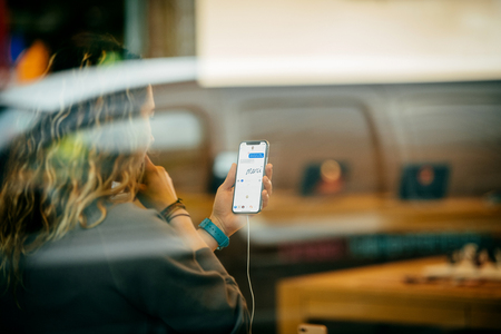 STRASBOURG, FRANCE - NOV 3, 2017: Street view of latest Apple iPhone X in Apple Store with woman using the iMessage Animoji and chat message writing Merci (Thank You) messageのeditorial素材