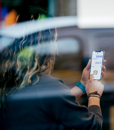 STRASBOURG, FRANCE - NOV 3, 2017: Street reflection of latest Apple iPhone X goes on sale in Apple Store worldwide with woman trying the fun Animoji, laugh Face IDのeditorial素材