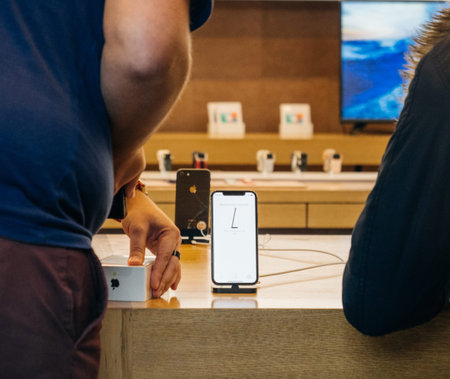 STRASBOURG, FRANCE - NOV 3, 2017: Apple Genius selling scanning the latest Apple iPhone X to first customers in France at Apple Storeのeditorial素材