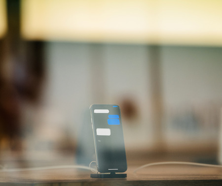 STRASBOURG, FRANCE - NOV 3, 2017: Latest Apple iPhone X goes on sale in Apple Store worldwide - demonstration animation of the phone charging in docking stationのeditorial素材
